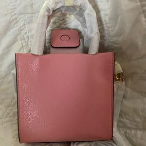 Dainty, small Coach purse. Dusty Rose color, tan handles and white sides.